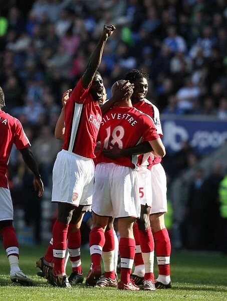 Mikael Silvestre, Kolo Toure, and Emmanuel Adebayor: Arsenal's Unstoppable Duo Celebrates Double Strike Against Wigan Athletic (4-1)