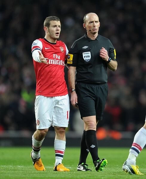 Mike Dean and Jack Wilshere: A Moment of Discussion during Arsenal vs Manchester City (2012-13)