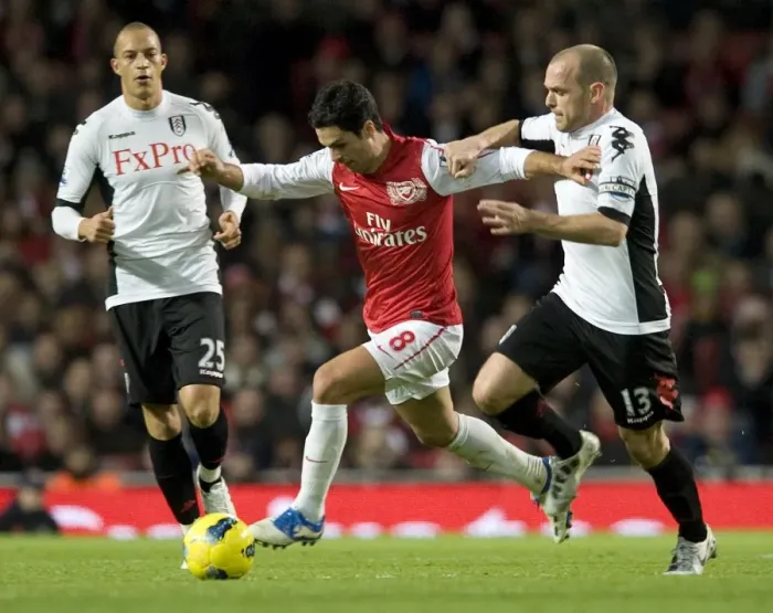 Framed Print : Mikel Arteta of Arsenal breaks past Danny Murphy of Fulham during the Barclays Premier League match between Arsenal and Fulham at Emirates Stadium on November 26, 2011 in London, England. Credit; Arsenal