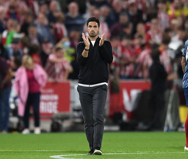 Mikel Arteta Celebrates with Arsenal Fans: Victory at Brentford in 2021-22 Premier League
