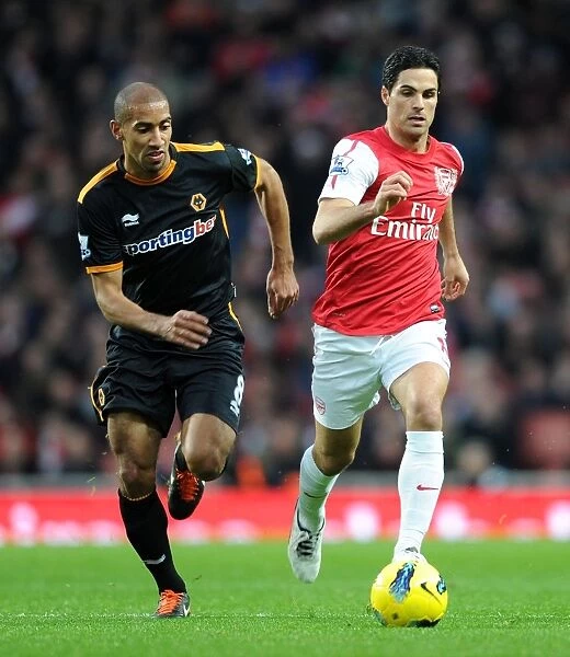 Mikel Arteta Chased by Karl Henry: Intense Moment from Arsenal vs. Wolverhampton Wanderers (2011-2012)