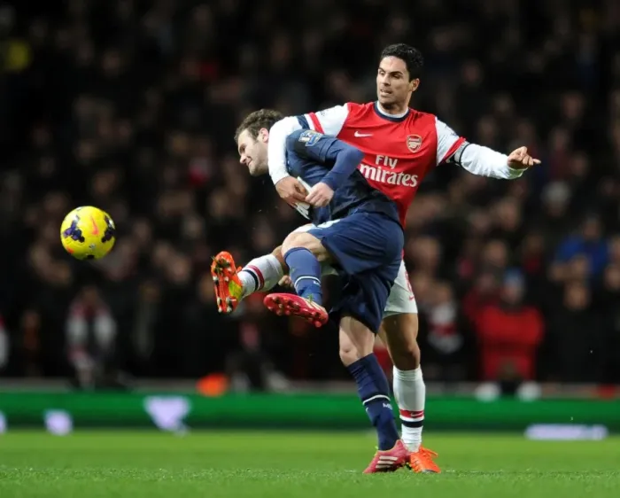 Framed Print : Mikel Arteta vs Juan Mata: Clash of Midfield Maestros in Arsenal vs Manchester United (2013-14)