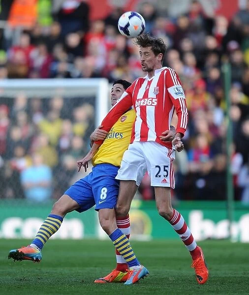 Mikel Arteta vs. Peter Crouch: Intense Clash in Stoke City vs. Arsenal (2013-14)
