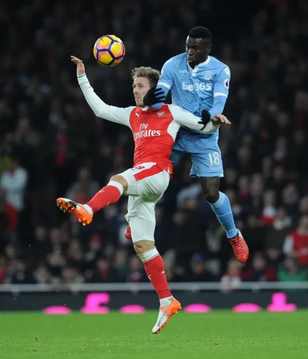 Framed Print : Monreal vs. Diouf: Heading Battle at Emirates Stadium - Arsenal v Stoke City, Premier League 2016-17
