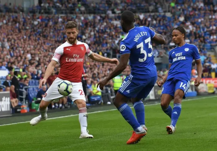 Framed Print : Mustafi Faces Off Against Hoilett: Intense Moment from Cardiff vs. Arsenal (2018-19)