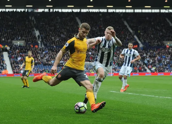 Framed Print : Mustafi Faces Off Against McClean: Intense Moment from West Bromwich Albion vs. Arsenal (2016-17) Framed Print : Mustafi Faces Off Against McClean: Intense Moment from West Bromwich Albion vs. Arsenal (2016-17)