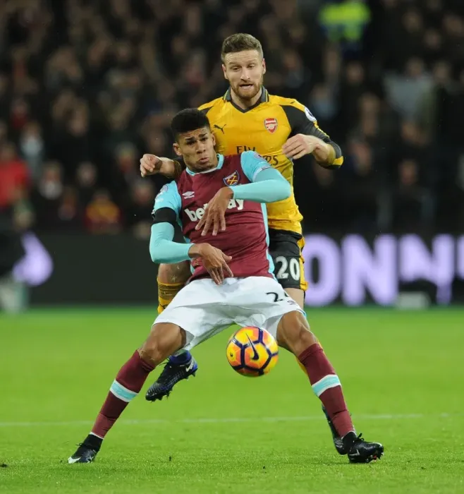 Framed Print : Mustafi vs Fletcher: Intense Battle in West Ham United vs Arsenal Premier League Clash