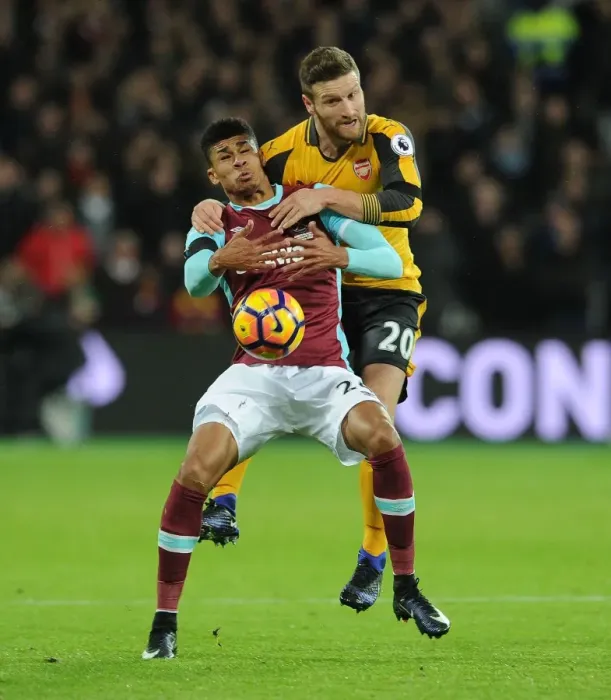 Framed Print : Mustafi vs Fletcher: Intense Clash in West Ham United vs Arsenal Premier League Match