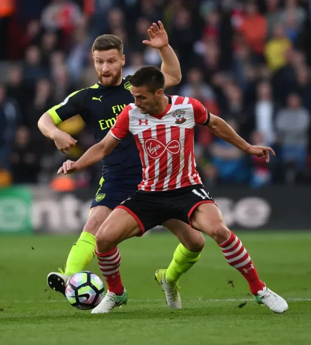 Framed Print : Mustafi vs. Tadic: Intense Clash Between Southampton and Arsenal Players