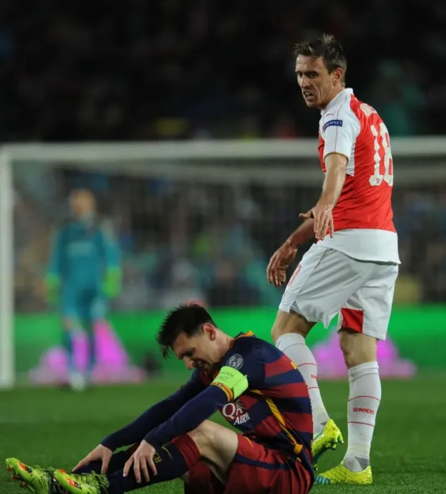 Framed Print : Nacho Monreal Fouls Lionel Messi: Intense Barcelona vs. Arsenal UEFA Champions League Clash