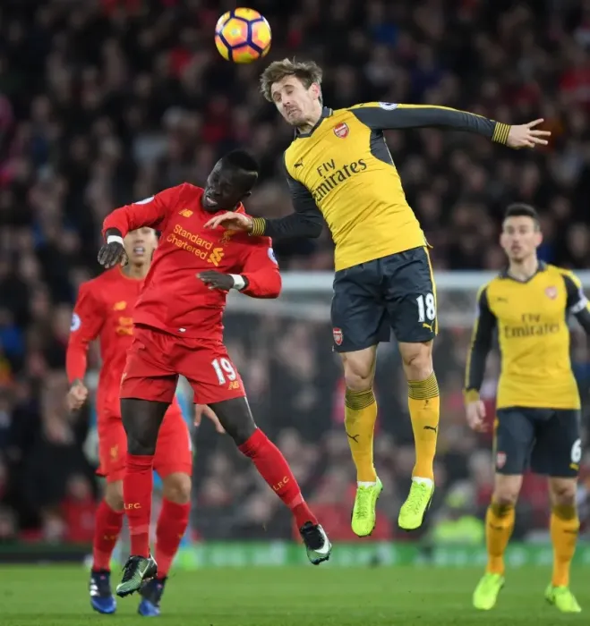 Framed Print : Nacho Monreal Leaps Ahead: Liverpool vs. Arsenal, Premier League 2016-17