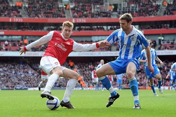 Nicklas Bendtner (Arsenal) Jamie McCombe (Huddersfield). Arsenal 2:1 Huddersfield Town
