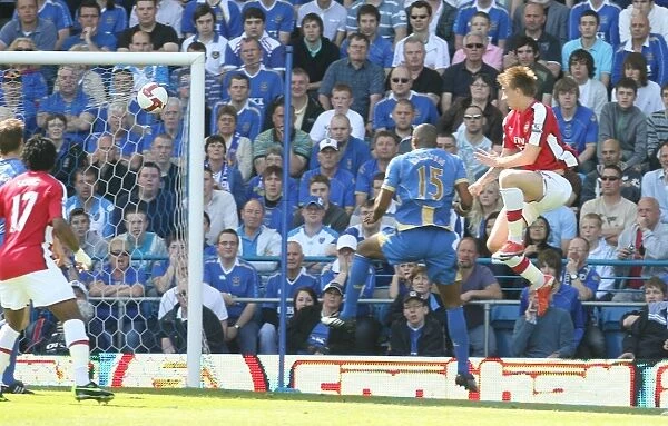 Nicklas Bendtner heads past Portsmouth goalkeeper David