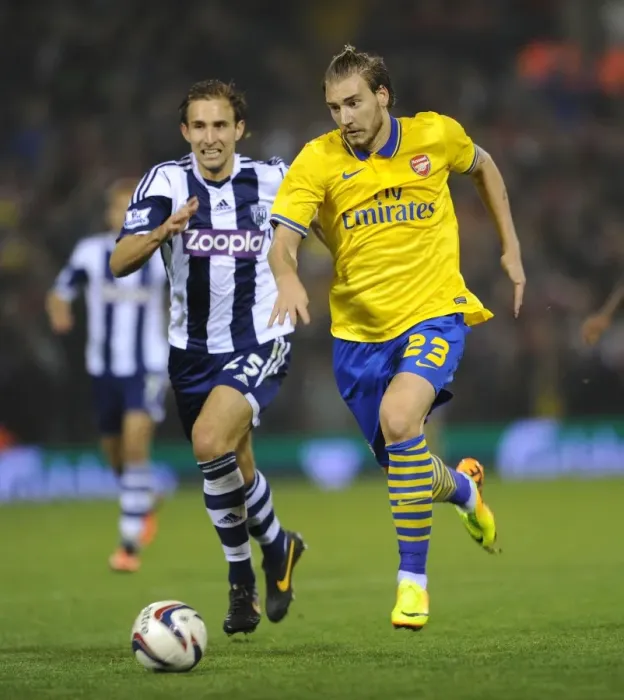 Framed Print : Nicklas Bendtner vs Craig Dawson: A Riveting Moment from Arsenal's Capital One Cup Clash with West Bromwich Albion (September 2013)