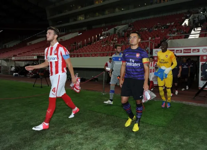 Framed Print : Nico Yennaris and Konstantinos Rougkalas Lead Out Teams at Olympiacos vs. Arsenal NextGen Series Match
