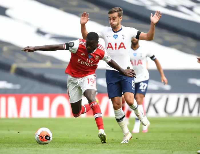 Framed Print : Nicolas Pepe Breaks Past Harry Winks: Intense Moment from Tottenham vs. Arsenal Premier League Clash (2019-20)