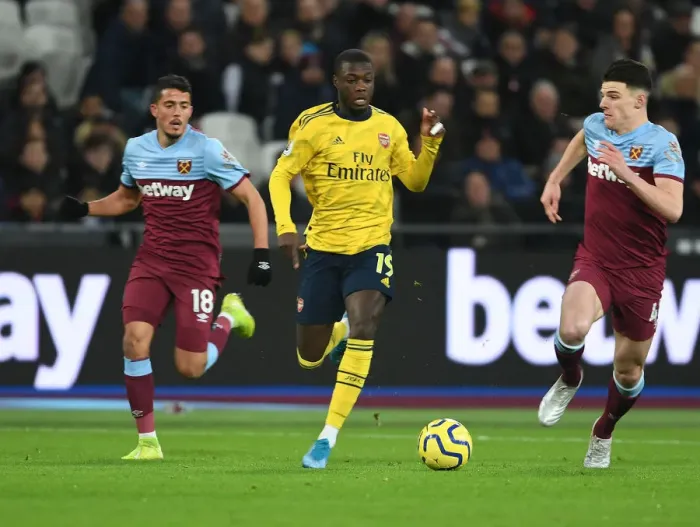 Framed Print : Nicolas Pepe Breaks Past West Ham's Fornals and Rice in Arsenal's Premier League Clash Framed Print : Nicolas Pepe Breaks Past West Ham's Fornals and Rice in Arsenal's Premier League Clash