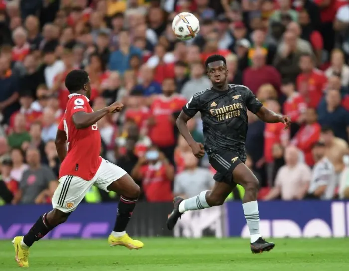 Framed Print : Nketiah vs Malacia: A Premier League Battle at Old Trafford Framed Print : Nketiah vs Malacia: A Premier League Battle at Old Trafford