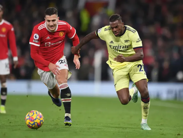 Framed Print : Nuno Tavares vs Diogo Dalot: A Clash at Old Trafford - Premier League 2020-21: Manchester United vs Arsenal