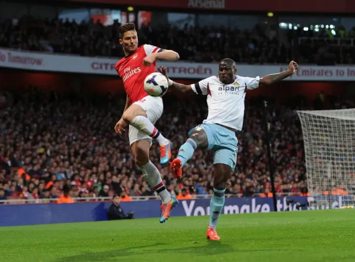 Framed Print : Olivier Giroud (Arsenal) Guy Demel (West Ham). Arsenal 3: 1 West Ham United. Barclays Premier League Framed Print : Olivier Giroud (Arsenal) Guy Demel (West Ham). Arsenal 3: 1 West Ham United. Barclays Premier League