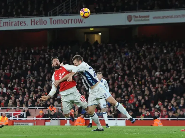 Framed Print : Olivier Giroud Scores Under Pressure Against Gareth McAuley: Arsenal vs. West Bromwich Albion, Premier League 2016-17