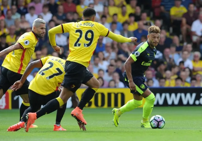 Framed Print : Oxlade-Chamberlain's Star Performance: Arsenal Triumphs 3-1 over Capoue and Watford in Premier League