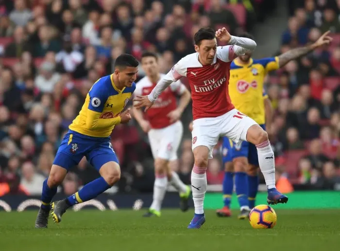 Framed Print : Ozil vs. Elyounoussi: A Battle of Skills in Arsenal vs. Southampton Premier League Clash