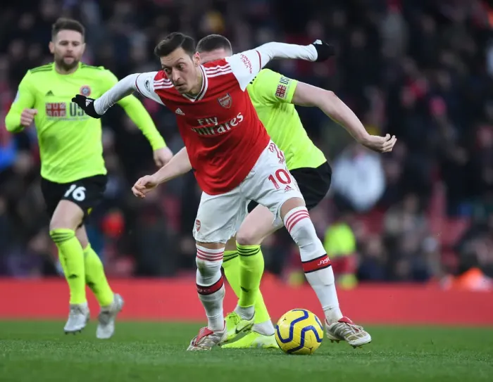 Framed Print : Ozil vs. Lundstram: A Battle of Midfield Masters in Arsenal vs. Sheffield United Premier League Clash Framed Print : Ozil vs. Lundstram: A Battle of Midfield Masters in Arsenal vs. Sheffield United Premier League Clash