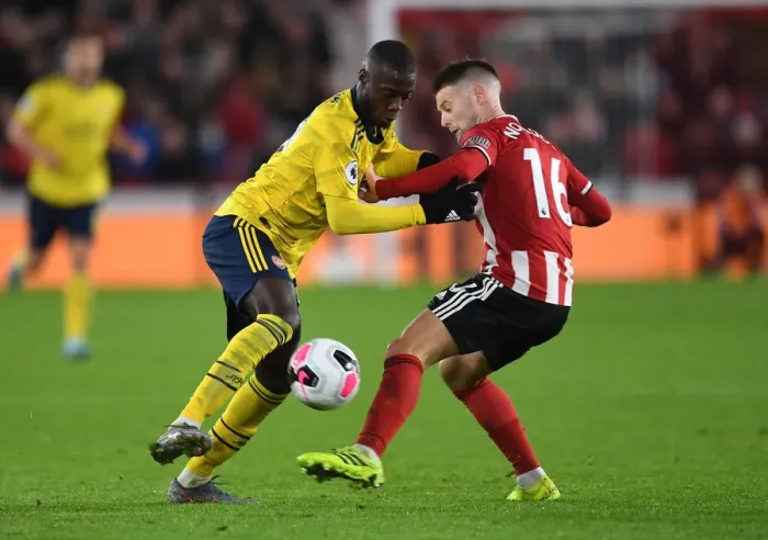 Framed Print : Pepe vs Norwood: Clash at Bramall Lane - Sheffield United vs Arsenal, Premier League 2019-20 Framed Print : Pepe vs Norwood: Clash at Bramall Lane - Sheffield United vs Arsenal, Premier League 2019-20