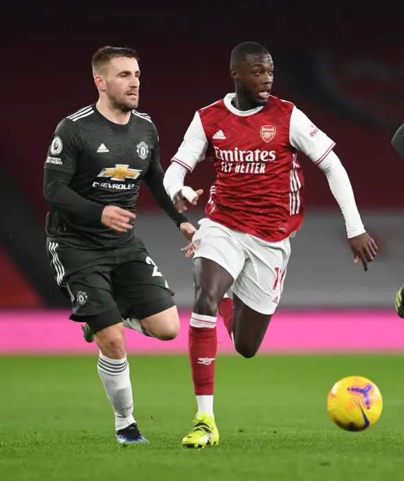 Framed Print : Pepe vs Shaw: Empty Emirates Showdown - Arsenal vs Manchester United in the Premier League Amidst Coronavirus Restrictions (2020-21)