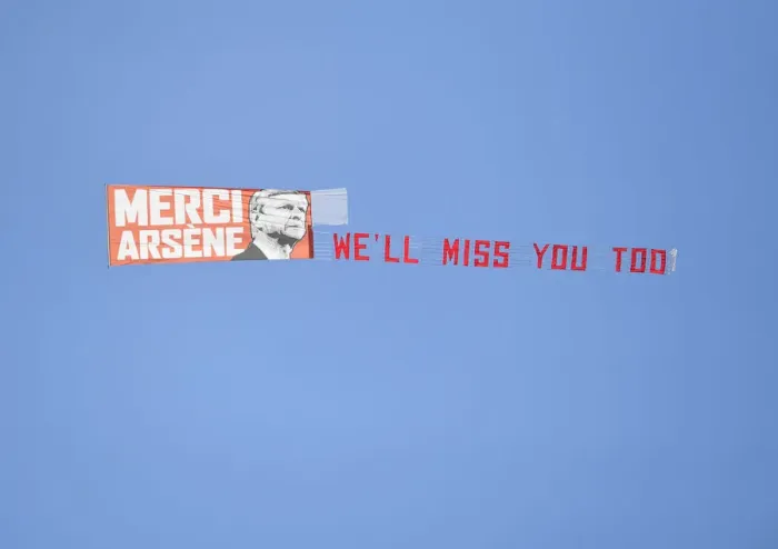 Framed Print : Plane Flies Over Huddersfield Stadium with Arsene Wenger Banner during Arsenal Match Framed Print : Plane Flies Over Huddersfield Stadium with Arsene Wenger Banner during Arsenal Match