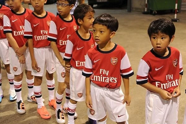 Player Escorts Align in Football Tunnel: Kitchee FC vs. Arsenal FC (2012)