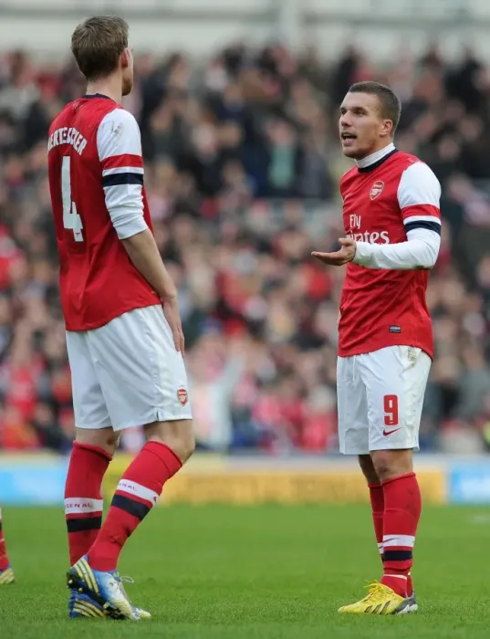 Framed Print : Podolski and Mertesacker in Deep Conversation: Brighton vs Arsenal, FA Cup 2012-13