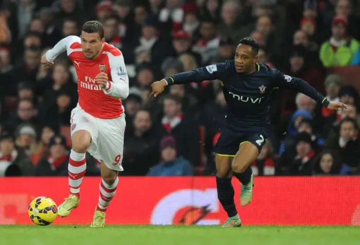 Framed Print : Podolski Outmaneuvers Clyne: Arsenal vs Southampton, Premier League 2014-15