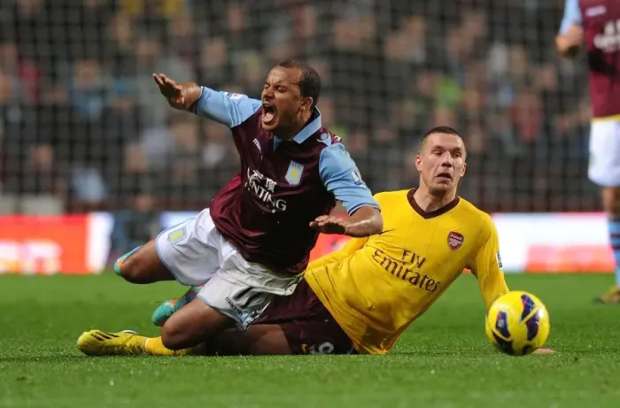 Framed Print : Podolski Tackles Agbonlahor: Aston Villa vs Arsenal, Premier League 2012-13