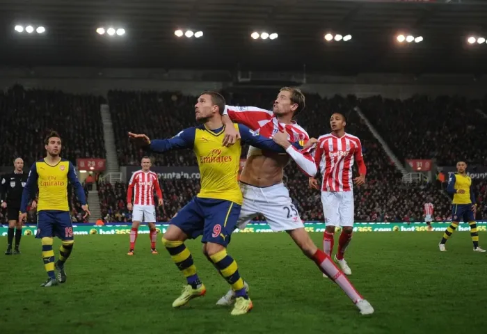 Framed Print : Podolski vs Crouch: Intense Battle at Britannia Stadium - Stoke City vs Arsenal, Premier League 2014-15