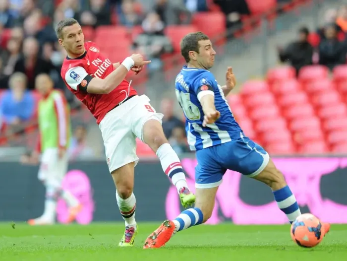 Framed Print : Podolski vs McArthur: Intense Moment at the FA Cup Semi-Final between Arsenal and Wigan Framed Print : Podolski vs McArthur: Intense Moment at the FA Cup Semi-Final between Arsenal and Wigan