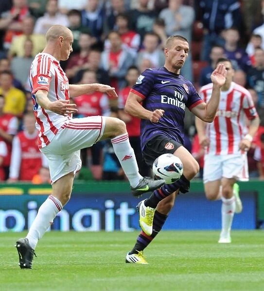 Podolski vs. Wilkinson: Intense Clash in Stoke City vs. Arsenal (2012-13)