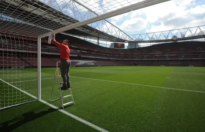 Framed Print : Preparing for the Clash: Arsenal Groundsman Readies Emirates Stadium for Manchester City