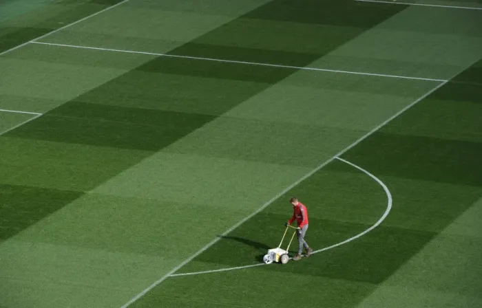 Framed Print : Preparing the Emirates Turf: Arsenal FC vs. FC Bayern Munich - UEFA Champions League Showdown