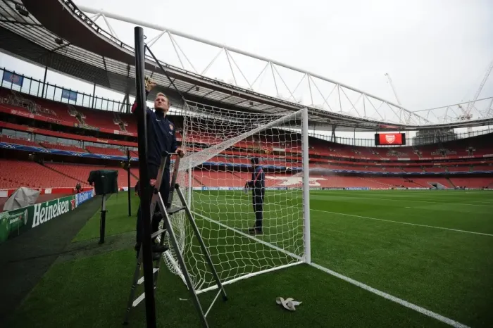 Framed Print : Preparing the North Bank: Arsenal Groundsmen Set Up for UEFA Champions League Clash (2013-14)