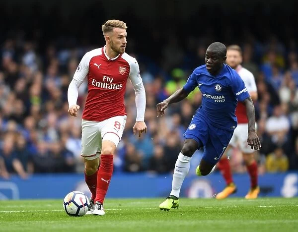 Ramsey Outmaneuvers Kante: Intense Battle between Arsenal's Aaron Ramsey and Chelsea's N'Golo Kante during the Premier League Match