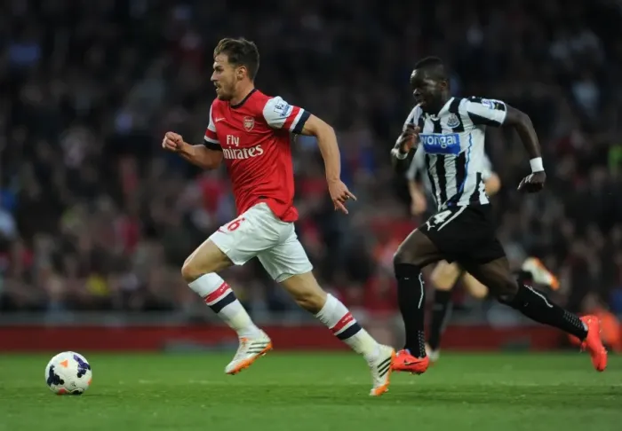 Framed Print : Ramsey Outpaces Tiote: Intense Rivalry in Arsenal vs. Newcastle United, Premier League, 2013 / 14