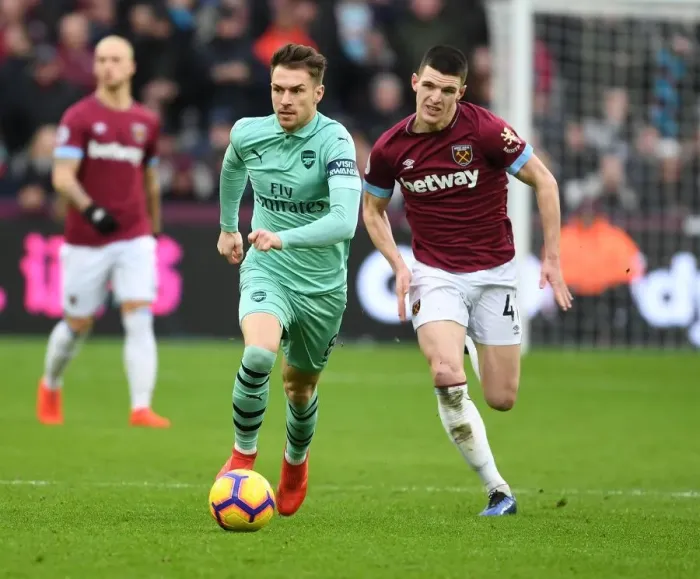 Framed Print : Ramsey Outsmarts Rice: Arsenal Star's Brilliant Maneuver in Premier League Clash Framed Print : Ramsey Outsmarts Rice: Arsenal Star's Brilliant Maneuver in Premier League Clash
