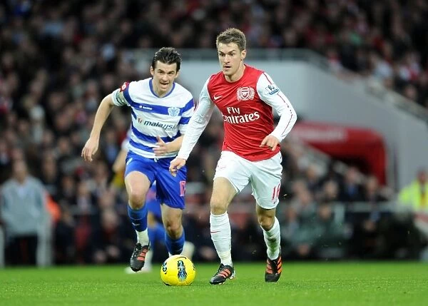 Ramsey vs. Barton: Intense Clash Between Arsenal's Aaron Ramsey and QPR's Joey Barton during Premier League Match