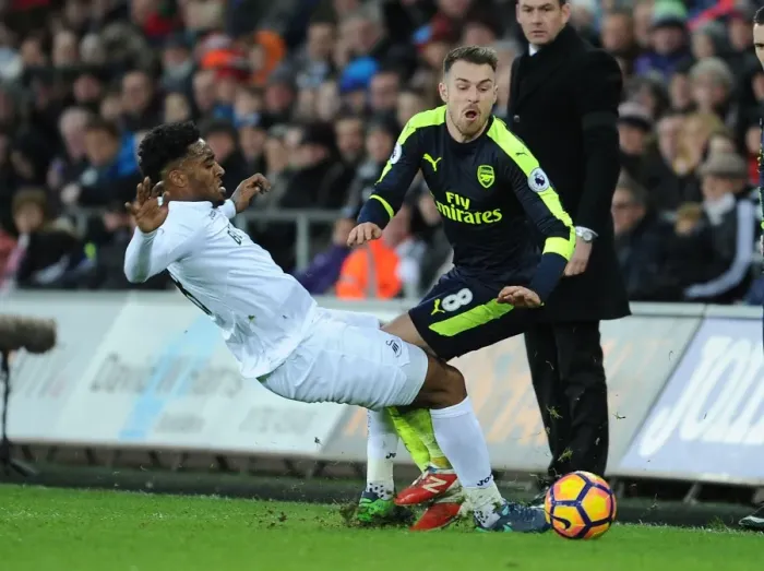 Framed Print : Ramsey vs. Fer: Intense Battle in Swansea City vs. Arsenal Premier League Clash