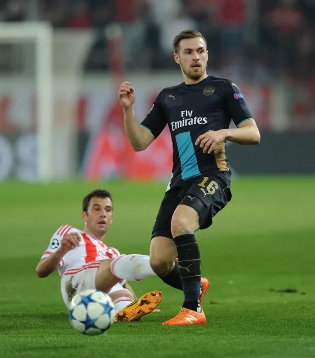 Framed Print : Ramsey vs Milivojevic: A Battle for Ball Possession in Olympiacos vs Arsenal UEFA Champions League Clash
