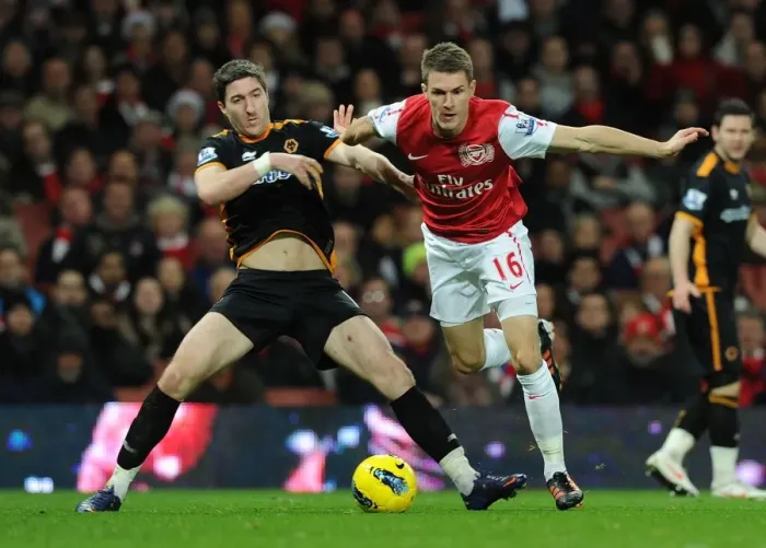 Framed Print : Ramsey vs. Ward: Intense Clash Between Arsenal's Aaron Ramsey and Wolverhampton Wanderers Stephen Ward in Premier League Match Framed Print : Ramsey vs. Ward: Intense Clash Between Arsenal's Aaron Ramsey and Wolverhampton Wanderers Stephen Ward in Premier League Match