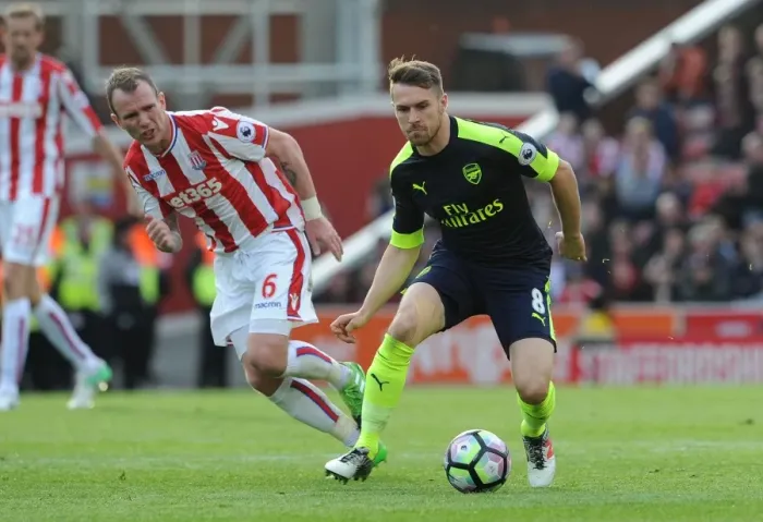 Framed Print : Ramsey vs. Whelan: Intense Battle in Stoke City vs. Arsenal Premier League Clash