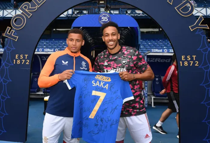 Framed Print : Rangers Welcome Arsenal: Aubameyang Honored with Saka Shirt by Tavernier